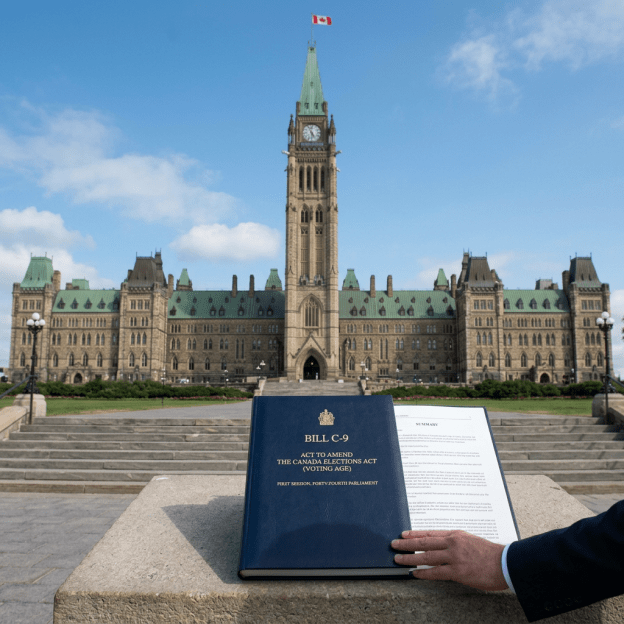 Bill C-9 titled Act to Amend the Canada Elections Act with Parliament building in background